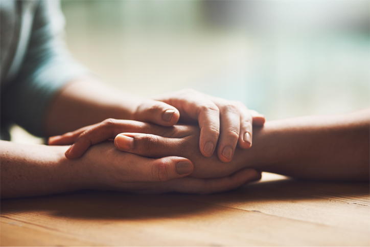 Two people holding hands.