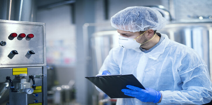 A worker with mask and scrubs on.