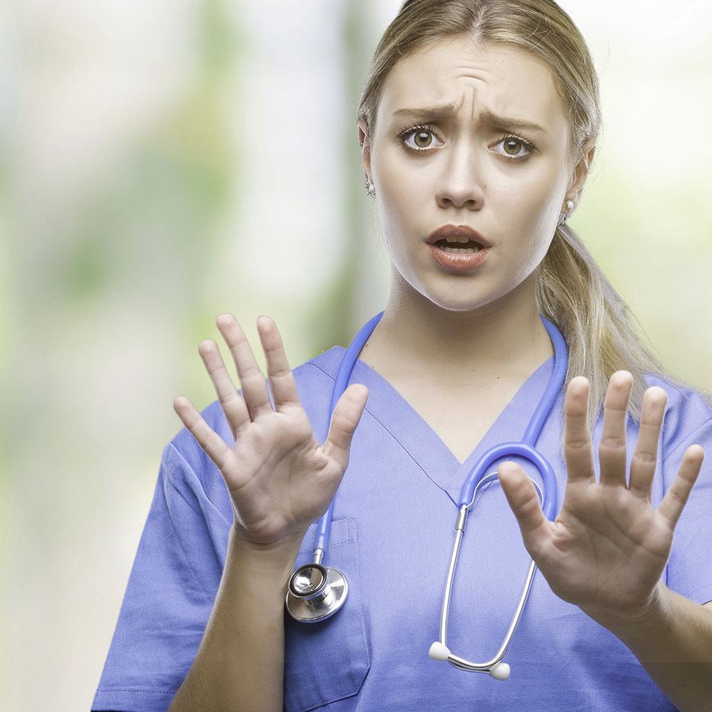 A nurse in scrubs looks puzzled.