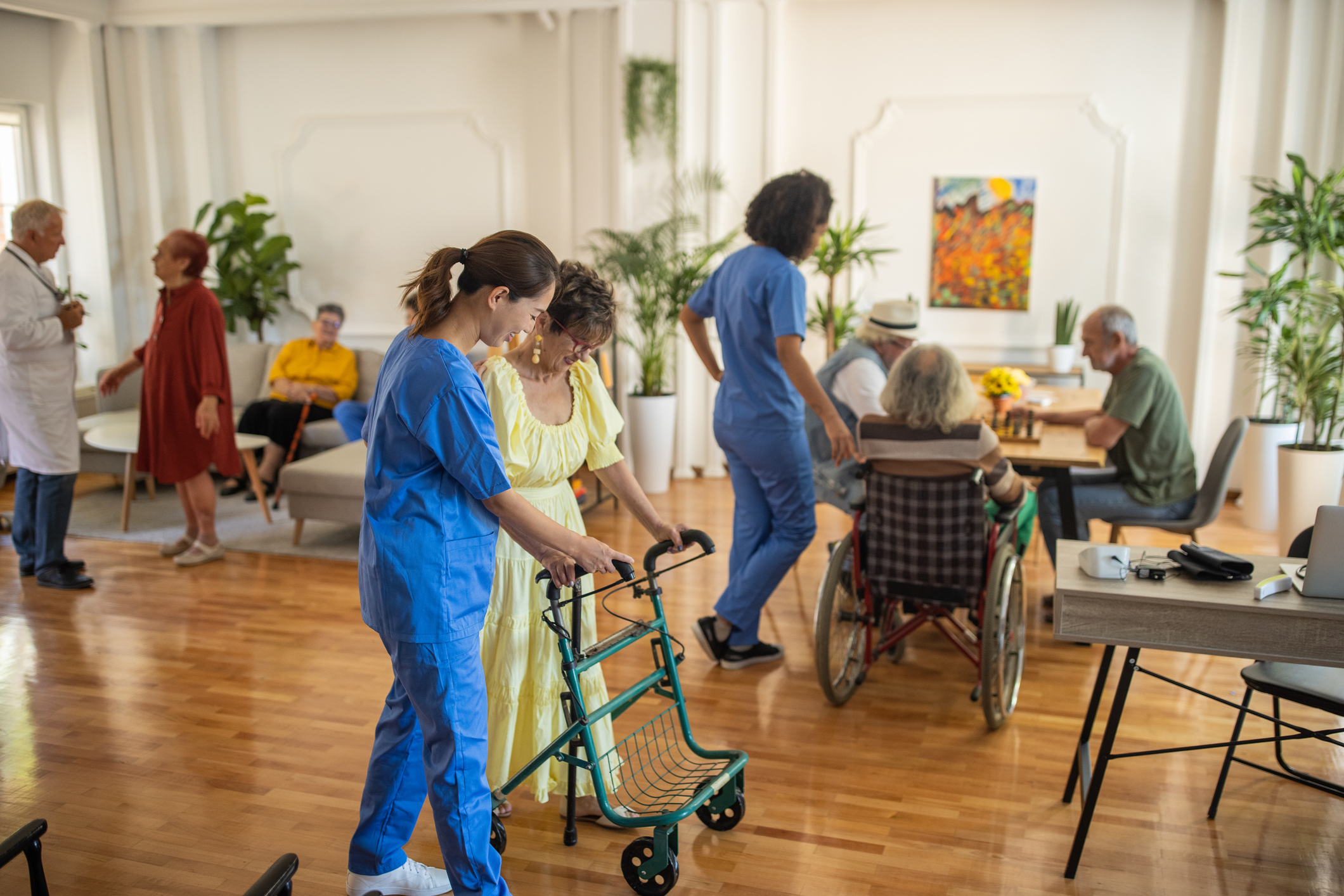 A nurse assists a patient at a nursing home.