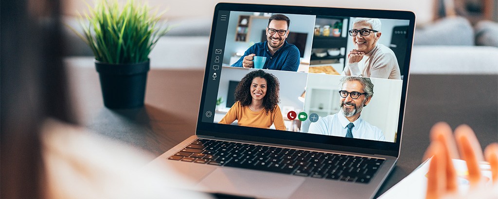 A group of medical professionals seen on a video call on a laptop computer