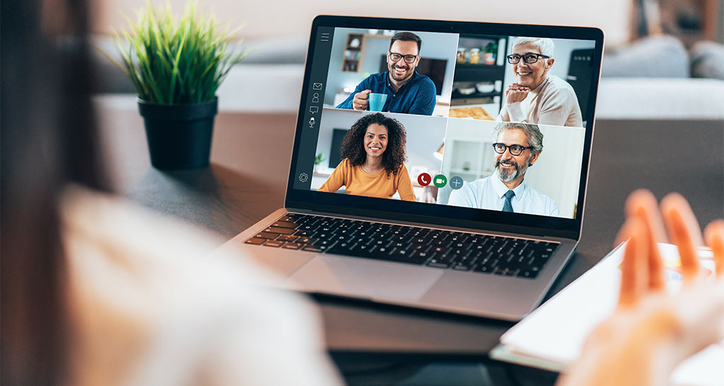 A group of medical professionals seen on a video call on a laptop computer