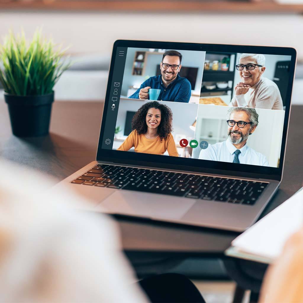 A group of medical professionals seen on a video call on a laptop computer