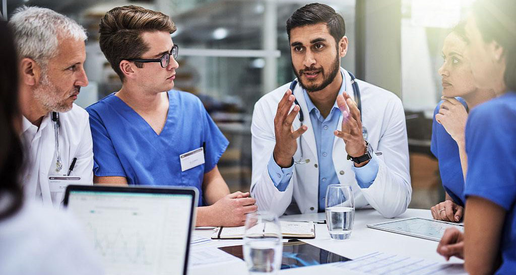 A team of doctors and nurses in a conference room