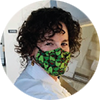 Female wearing a colorful mask covering her mouth and nose.